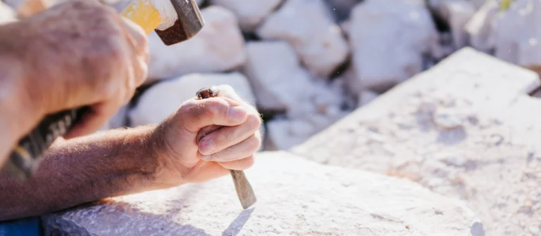 Steinmetz behaut einen Stein